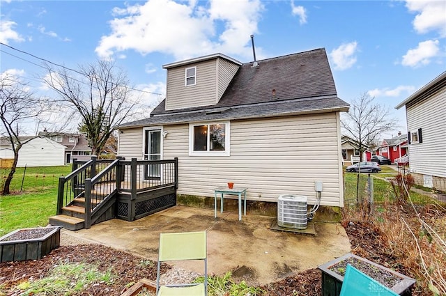 back of house featuring a wooden deck, a patio, and cooling unit