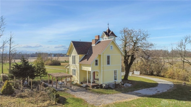 view of side of home featuring a lawn, cooling unit, and a patio area