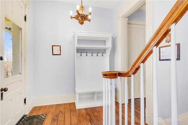 mudroom with an inviting chandelier and hardwood / wood-style flooring