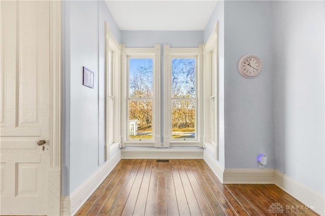 unfurnished room featuring dark wood-type flooring