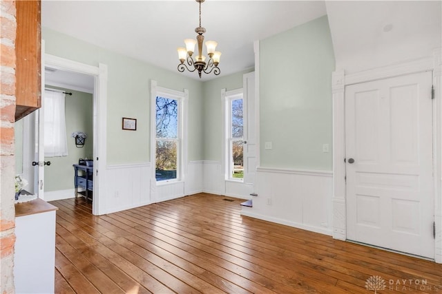 entrance foyer with dark wood-type flooring and a notable chandelier