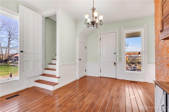 foyer entrance featuring light hardwood / wood-style floors and an inviting chandelier