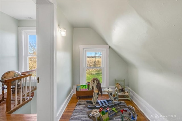 additional living space featuring hardwood / wood-style floors and vaulted ceiling