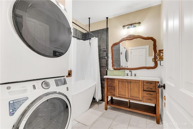 washroom featuring sink and stacked washer / drying machine