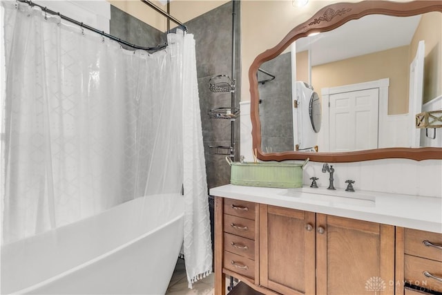 bathroom with vanity and stacked washer and clothes dryer