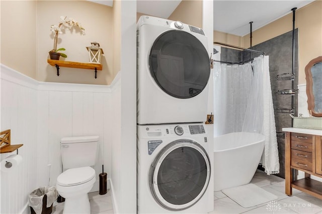 washroom with stacked washing maching and dryer