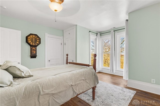 bedroom with ceiling fan and dark wood-type flooring