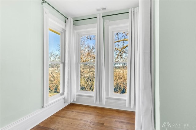 doorway to outside with wood-type flooring