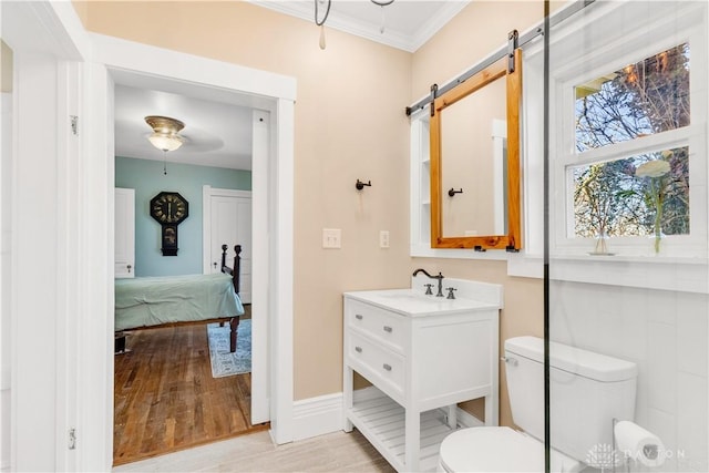 bathroom with hardwood / wood-style floors, vanity, toilet, and crown molding