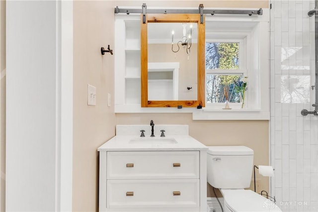 bathroom with vanity, toilet, and crown molding