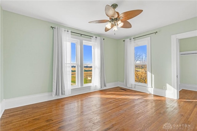 unfurnished room with wood-type flooring and ceiling fan