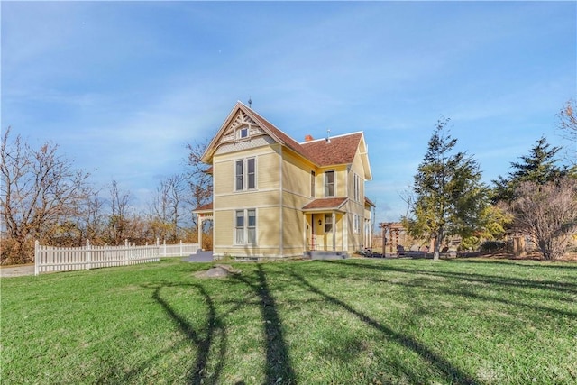 rear view of property with a yard