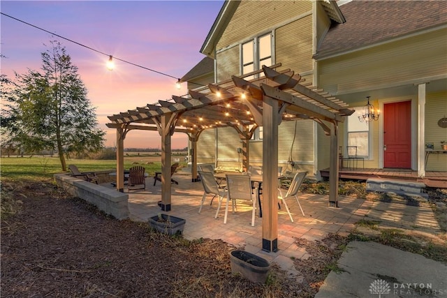 patio terrace at dusk featuring a pergola