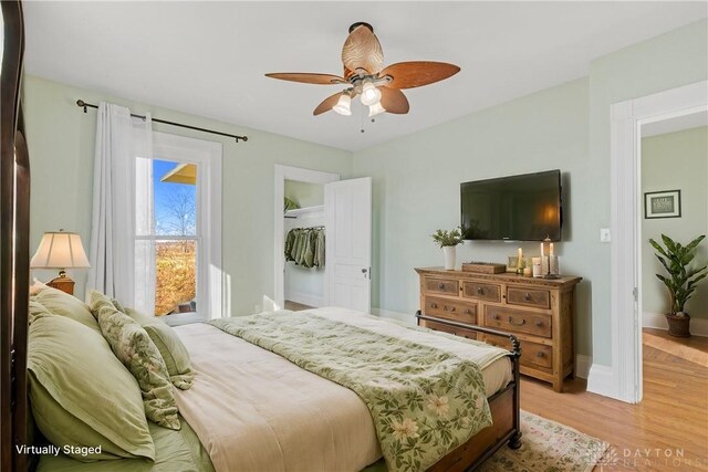 bedroom featuring ceiling fan, a closet, and light hardwood / wood-style flooring