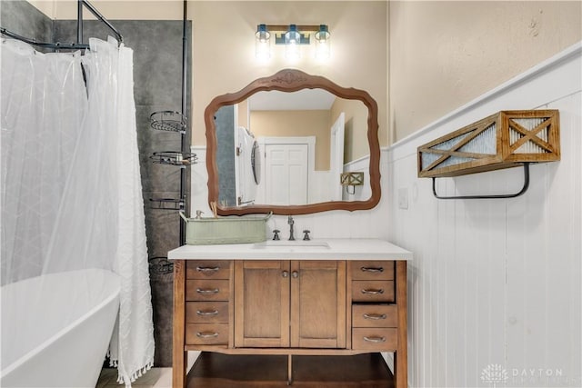 bathroom featuring vanity and independent shower and bath