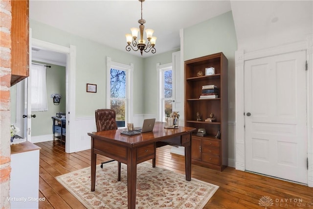 office featuring dark hardwood / wood-style flooring and a chandelier