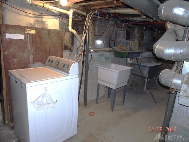 basement featuring washer / clothes dryer and sink