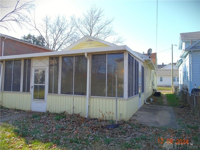 view of side of home featuring a sunroom