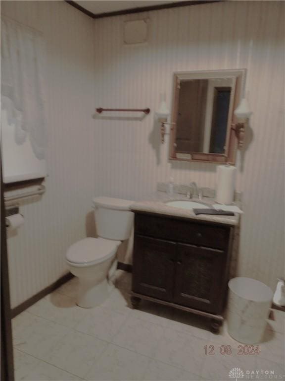 bathroom featuring toilet, vanity, and tile patterned flooring