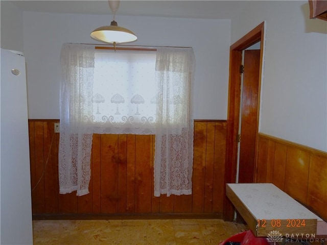 interior space featuring wooden walls