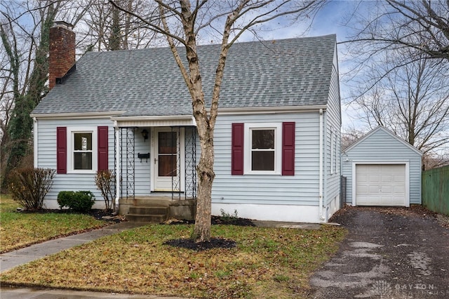 view of front of home with an outbuilding, a garage, and a front yard