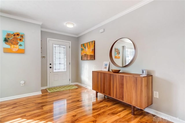 entryway with wood-type flooring and crown molding