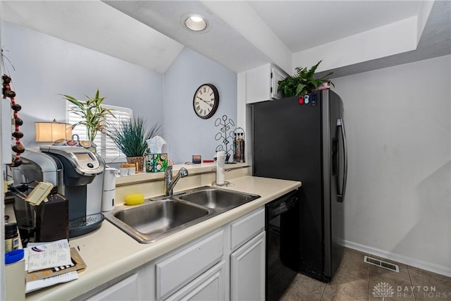 kitchen featuring sink, dishwasher, stainless steel fridge with ice dispenser, white cabinetry, and light tile patterned flooring