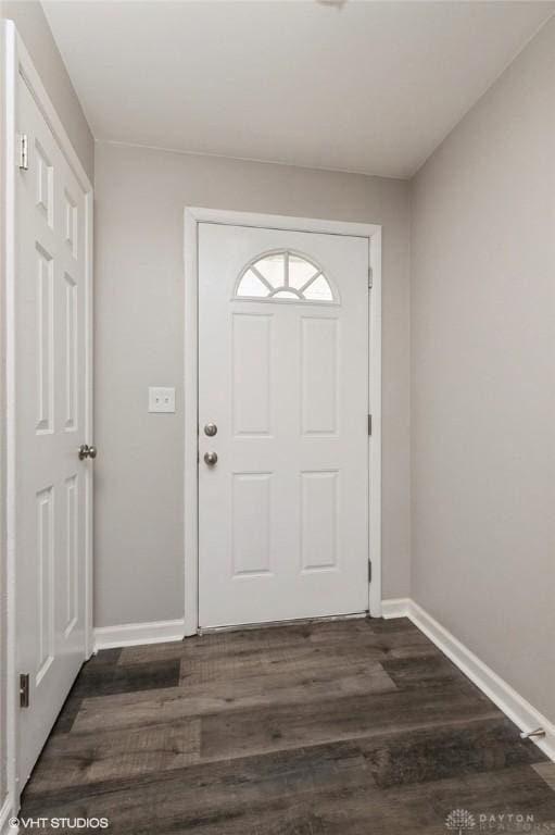 doorway to outside with dark wood-style floors and baseboards