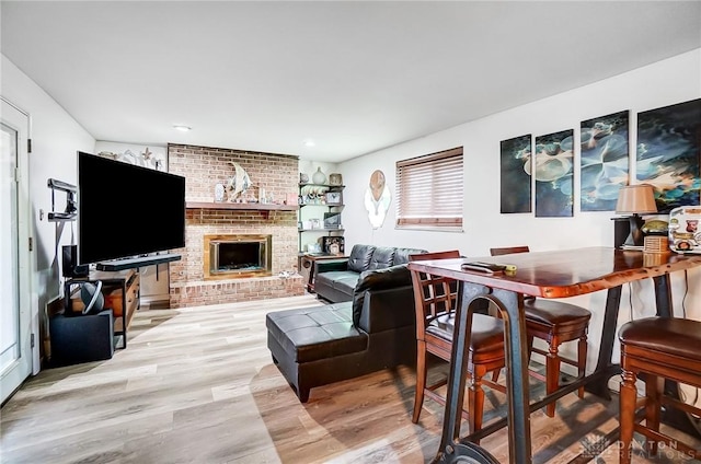 living room with a fireplace and light hardwood / wood-style floors