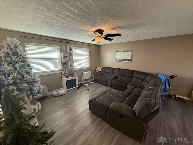 living room with hardwood / wood-style floors, a textured ceiling, and ceiling fan