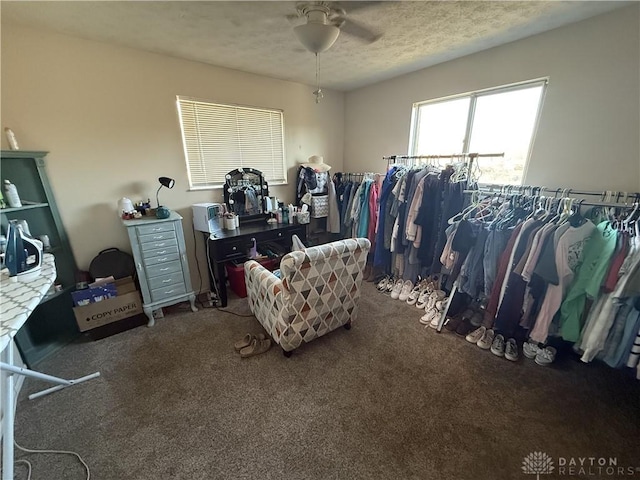 walk in closet with carpet flooring and ceiling fan