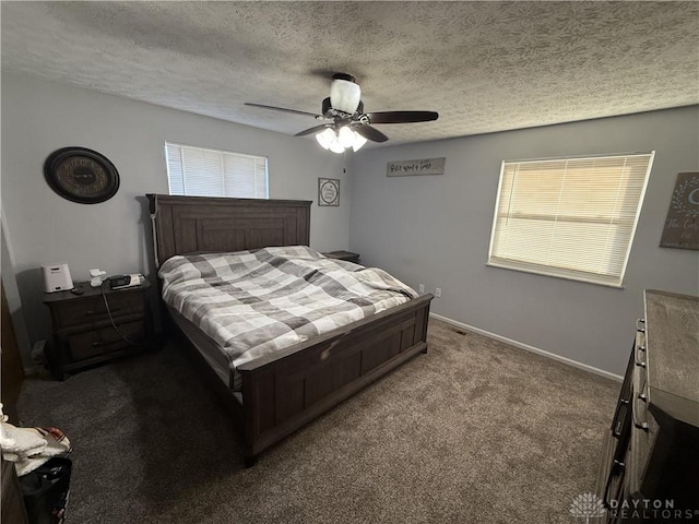 bedroom with carpet flooring, ceiling fan, a textured ceiling, and multiple windows