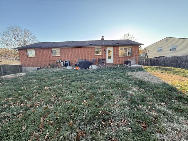 rear view of house featuring a yard