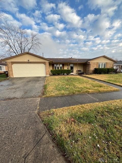 single story home with a garage and a front lawn