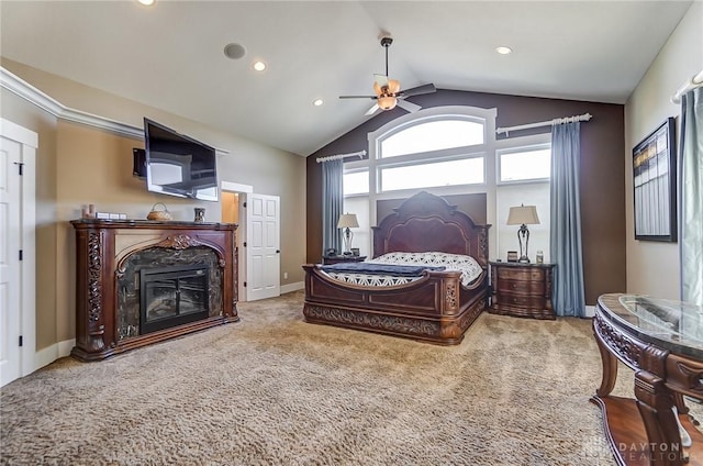 carpeted bedroom with ceiling fan, lofted ceiling, and a premium fireplace