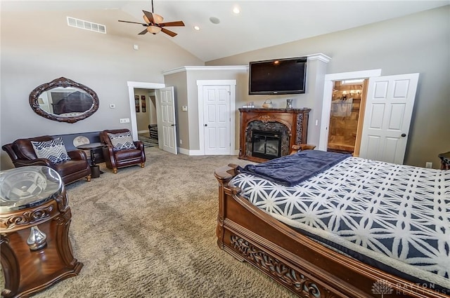 carpeted bedroom featuring ensuite bathroom, a high end fireplace, vaulted ceiling, and ceiling fan