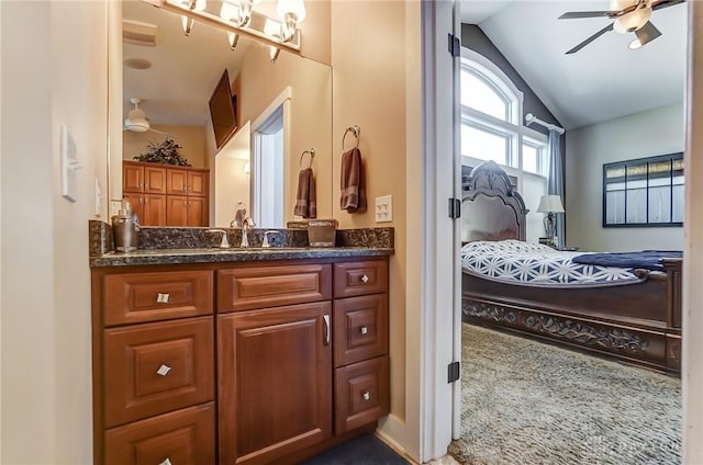 bathroom featuring ceiling fan, vanity, and lofted ceiling