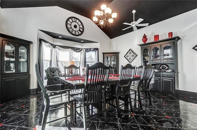 dining area with high vaulted ceiling and a notable chandelier