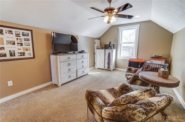 sitting room featuring ceiling fan, light carpet, and vaulted ceiling