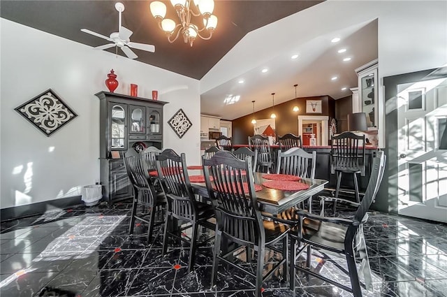 dining space featuring ceiling fan with notable chandelier and vaulted ceiling