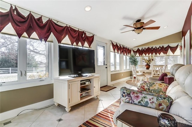 tiled living room featuring ceiling fan, a healthy amount of sunlight, and vaulted ceiling