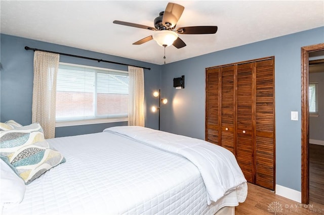 bedroom with ceiling fan and light wood-type flooring