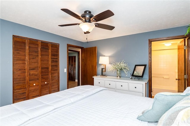 bedroom with a closet, ensuite bath, and ceiling fan