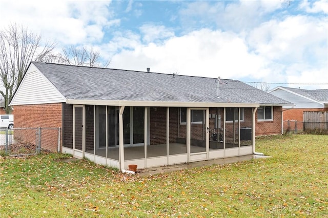 rear view of house featuring a yard