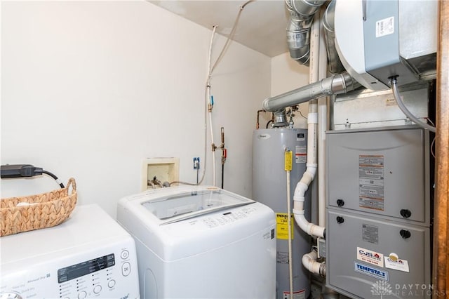 laundry area featuring washing machine and dryer and water heater