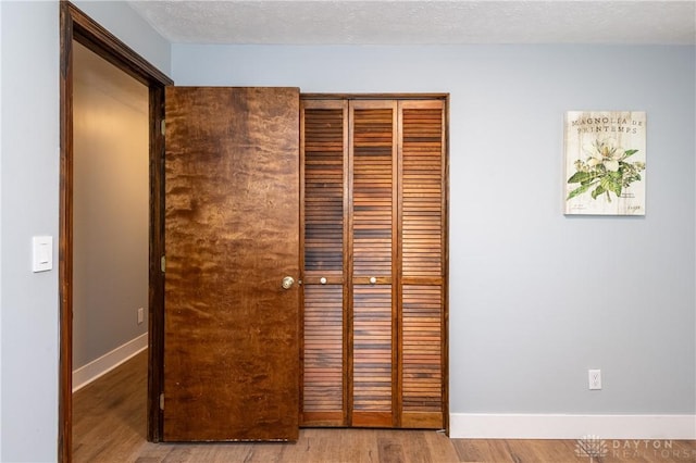 interior details with a textured ceiling and hardwood / wood-style flooring