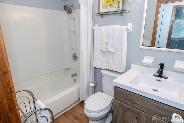 full bathroom featuring hardwood / wood-style floors, vanity, toilet, and shower / tub combo