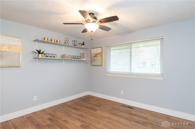 spare room with wood-type flooring and ceiling fan