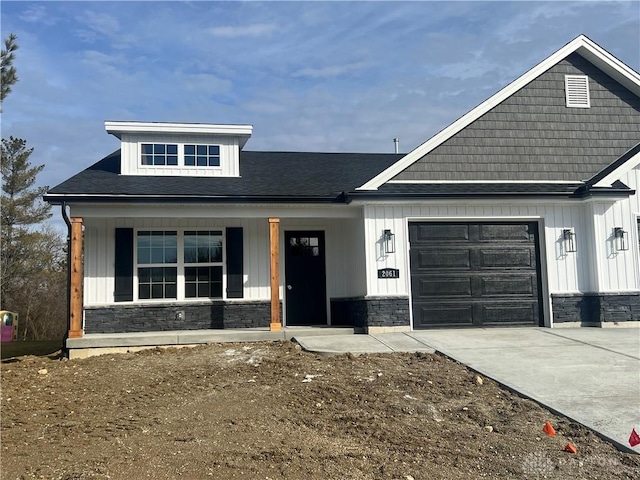 view of front facade with a garage and a porch