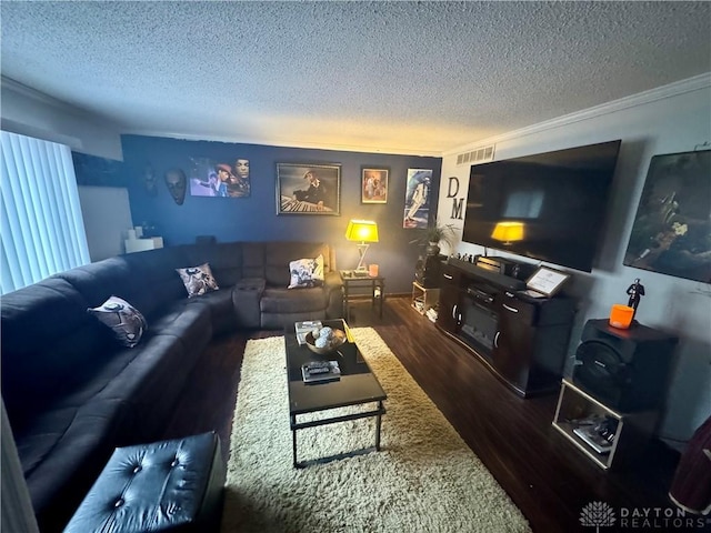 living room featuring a textured ceiling, crown molding, and dark wood-type flooring